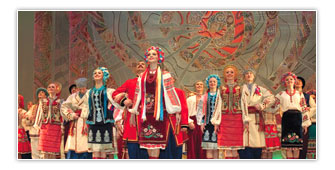 Performers dressed in colorful costumes at stage in a cultural event